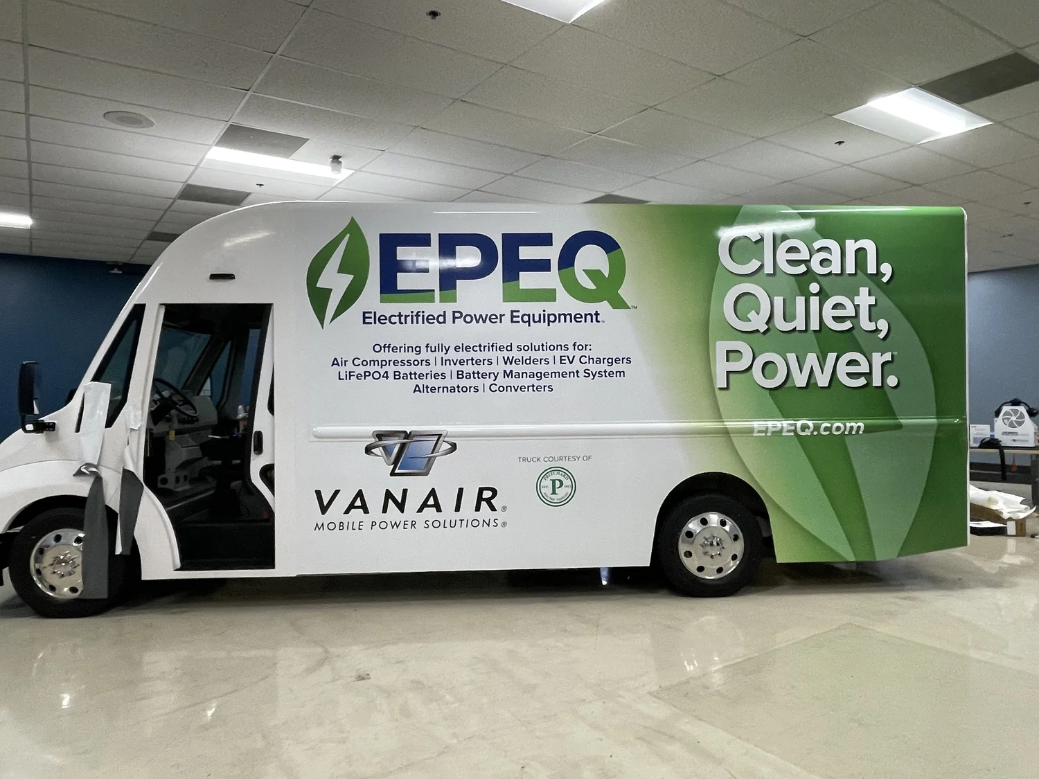 A white and green EPEQ commercial step van with company graphics